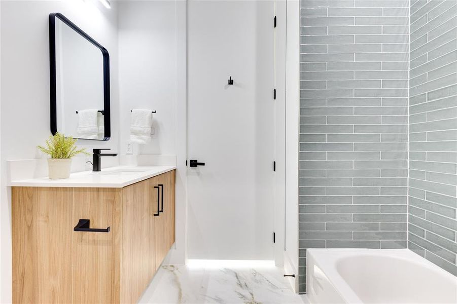 Bathroom featuring vanity and a washtub