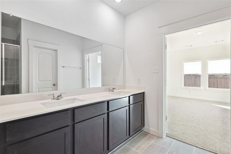 Bathroom featuring walk in shower and vanity