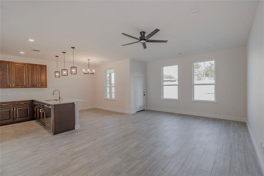 Kitchen with light wood-type flooring, sink, and plenty of natural light