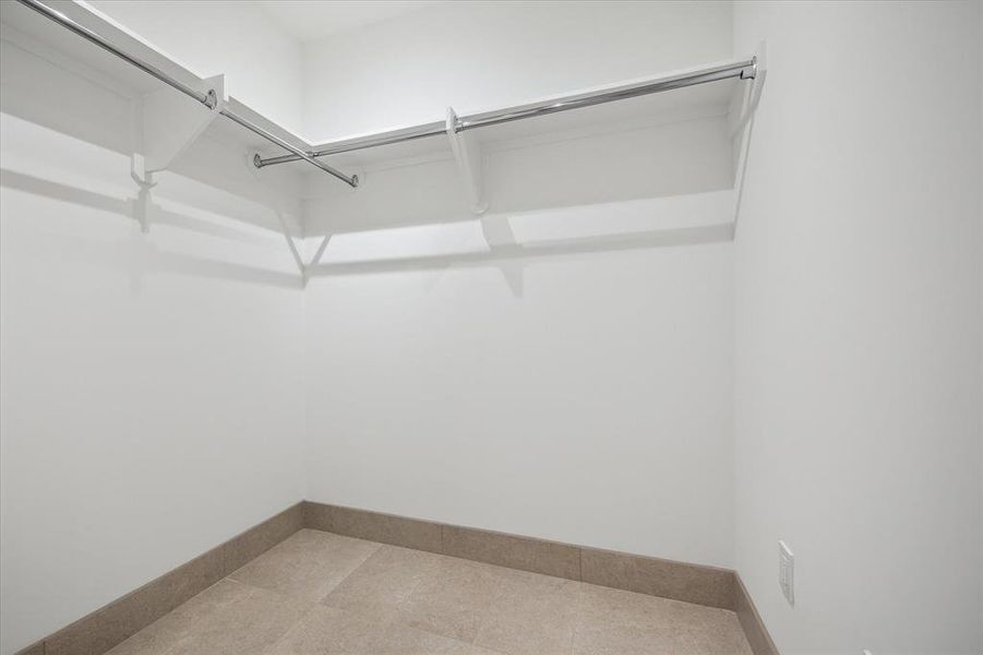 Spacious walk-in closet with ample hanging space.  No carpet!  Tiled space to reduce dust and allergens around your clothes and treasured wardrobe.accessories.