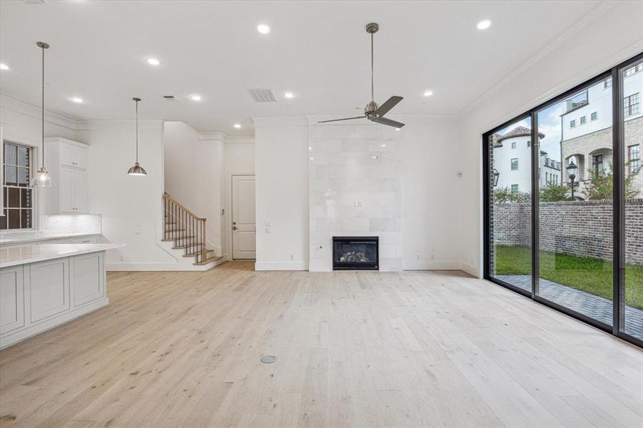 The kitchen opens to the living room with gas log fireplace. 10 ft sliding stacking doors lead to the back yard.