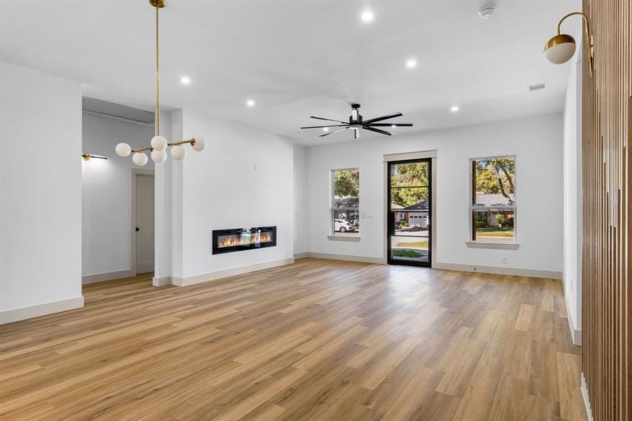 Unfurnished living room featuring ceiling fan and light hardwood / wood-style floors