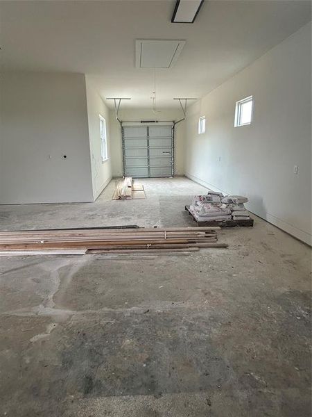 The rear of the tandem garage has a garage door, as does the front of the garage.