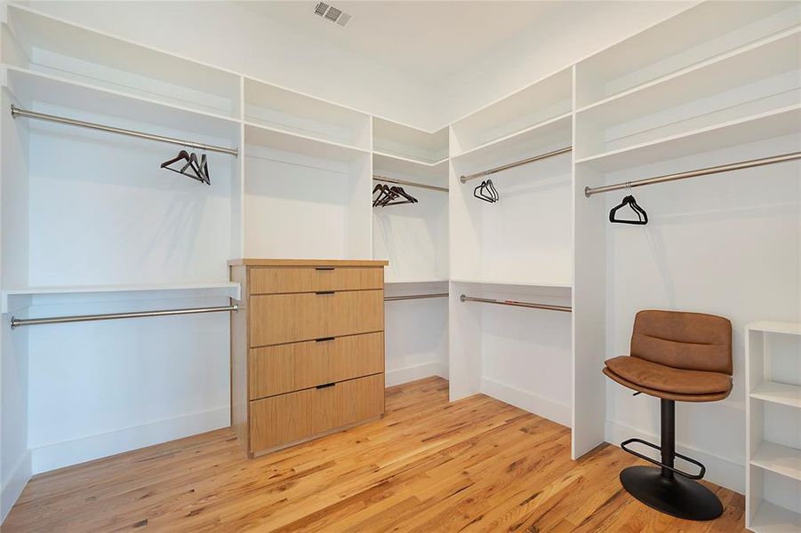 Spacious closet with light hardwood / wood-style floors