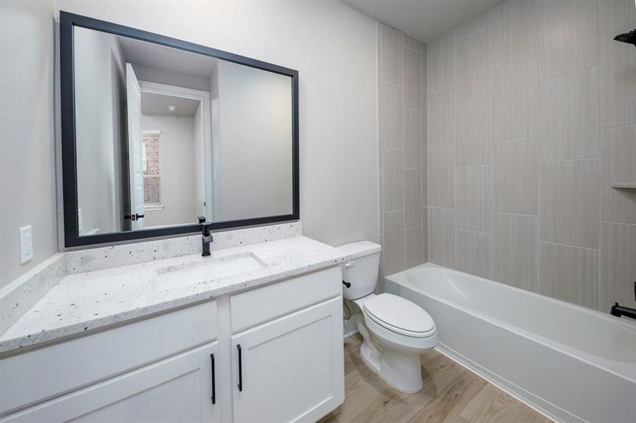 Each bathroom has expansive vanities offering an abundance of storage below.