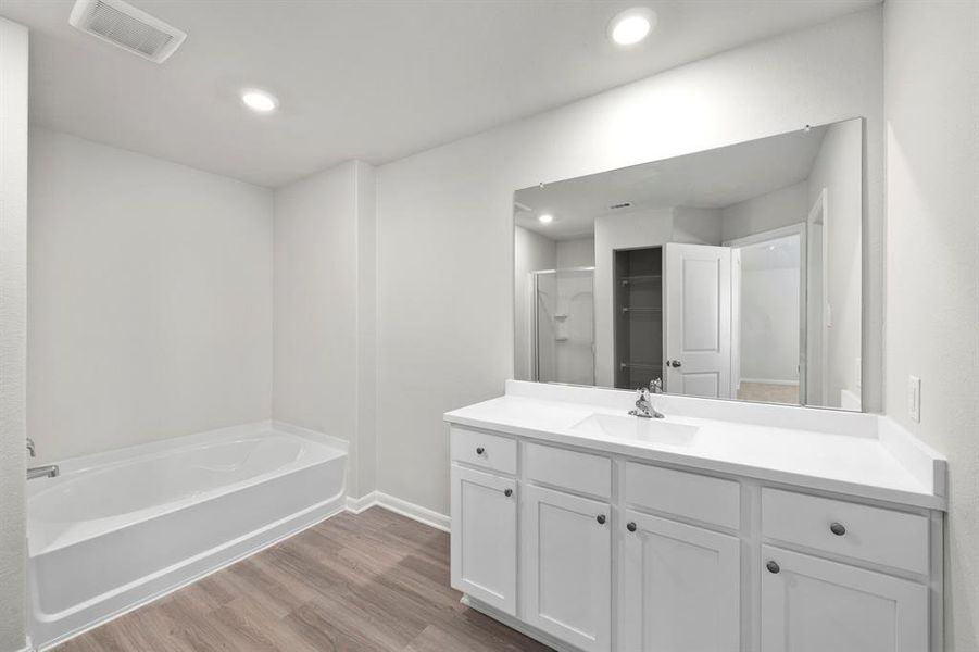 Luxurious primary bathroom with walk-in closets.