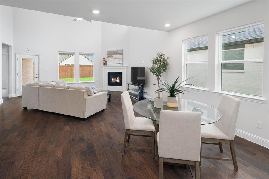 Dining area featuring dark wood-type flooring and a wealth of natural light