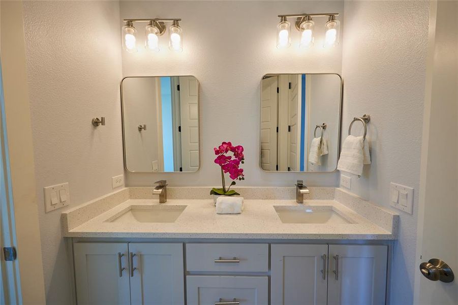 Bathroom featuring dual bowl vanity