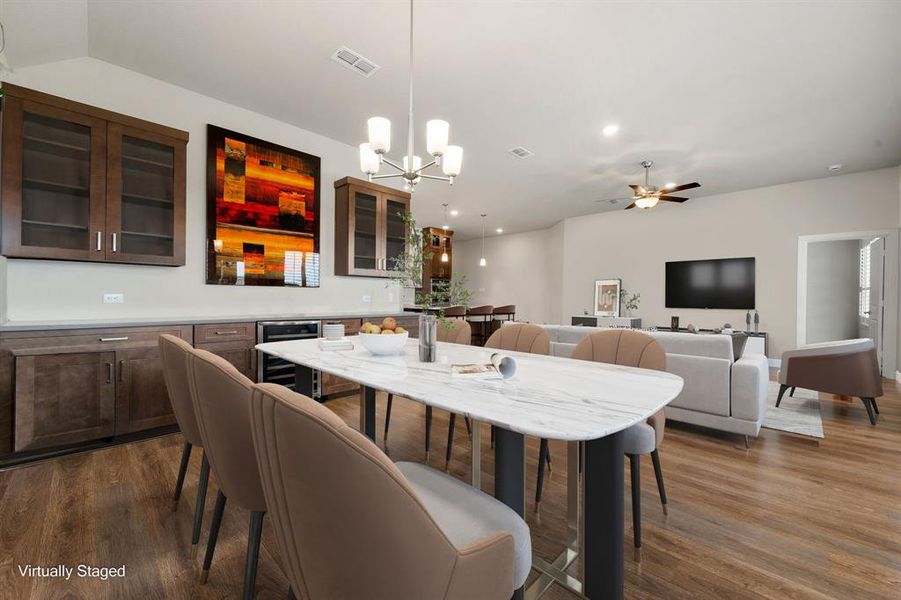 You and your guests will certainly dine in style in this amazing dining room! Featuring a gorgeous modern chandelier, large window with plantation shutters, neutral paint, high ceilings, and wood laminate flooring. Perfect space to entertain family and friends with a built in butler area and wine fridge.