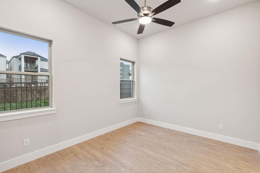 Unfurnished room featuring ceiling fan and light hardwood / wood-style floors