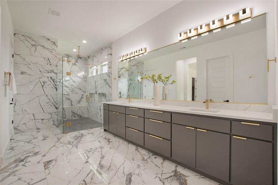 Bathroom with dual vanity, tile patterned flooring, and an enclosed shower