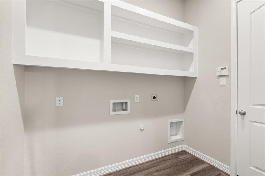 The laundry room layout is carefully planned for optimal workflow with designated areas for washing, drying, and storing.