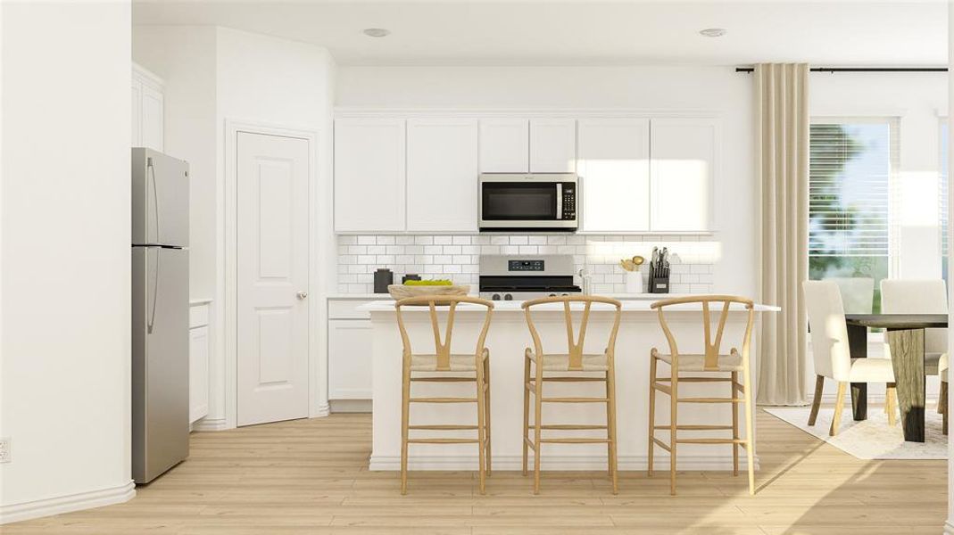 Kitchen featuring tasteful backsplash, stainless steel appliances, white cabinets, a center island, and light hardwood / wood-style flooring