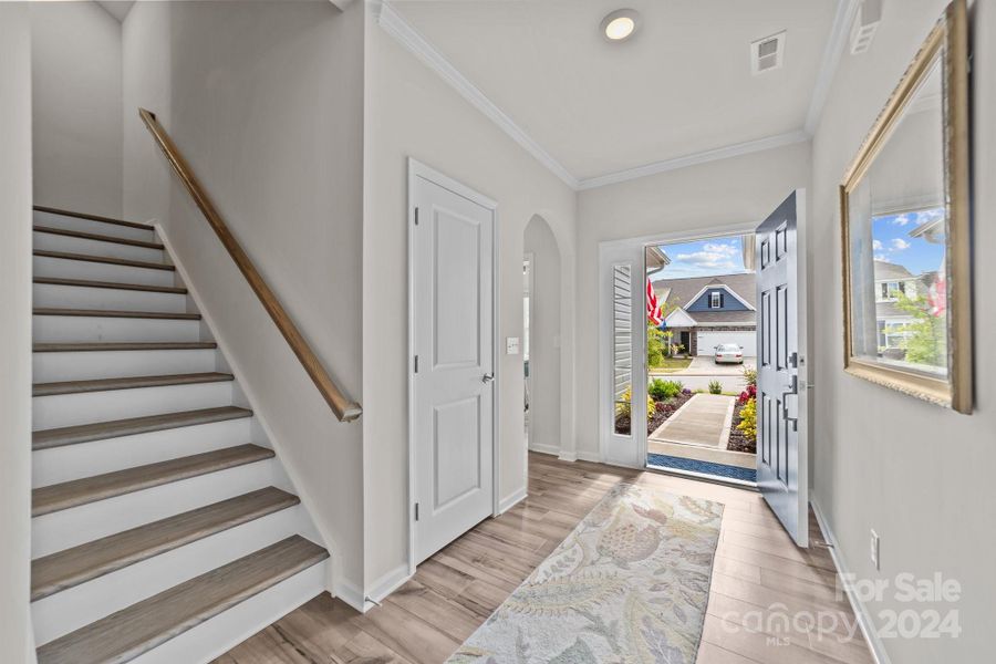 Looking toward entry, you see the arched doorway leading to full bath and office.  High ceilings and recessed lights give this an air of elegance