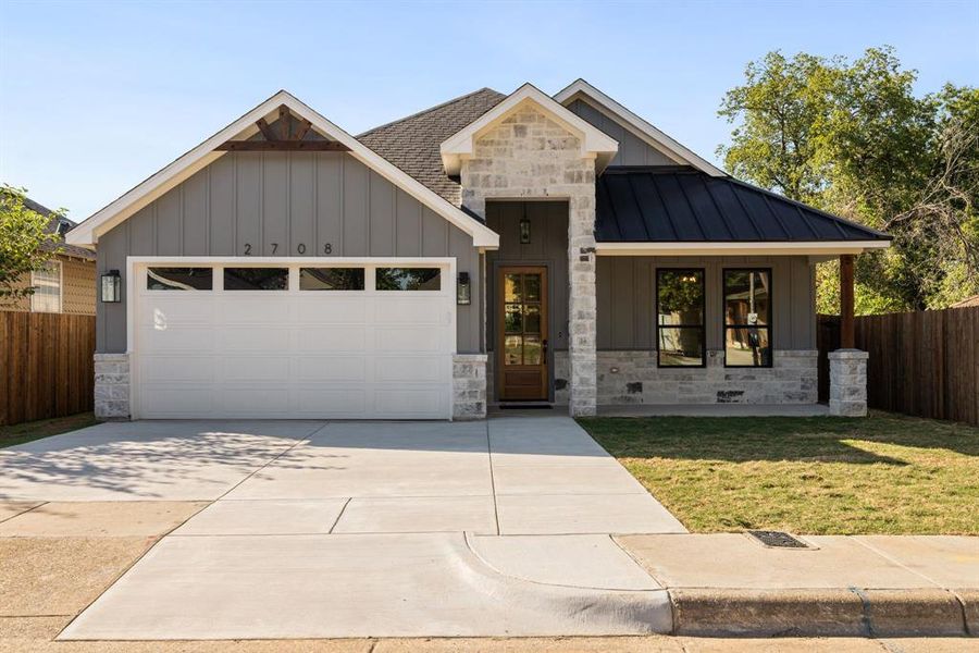 View of front facade with a front yard and a garage