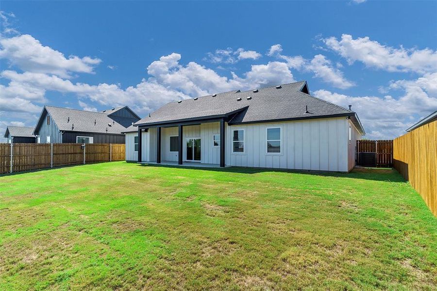 Rear view of house with a lawn