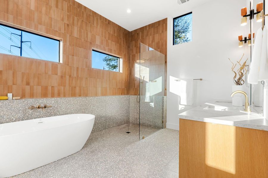 Gorgeous primary bath with high end finishes and designer tile