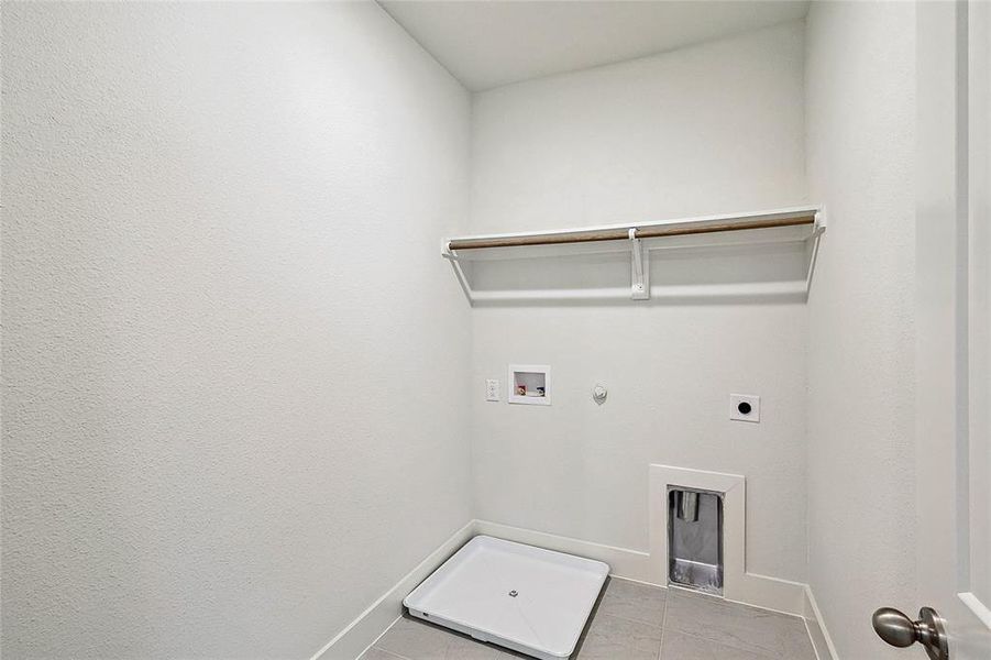 Laundry area featuring electric dryer hookup, washer hookup, tile patterned flooring, and hookup for a gas dryer