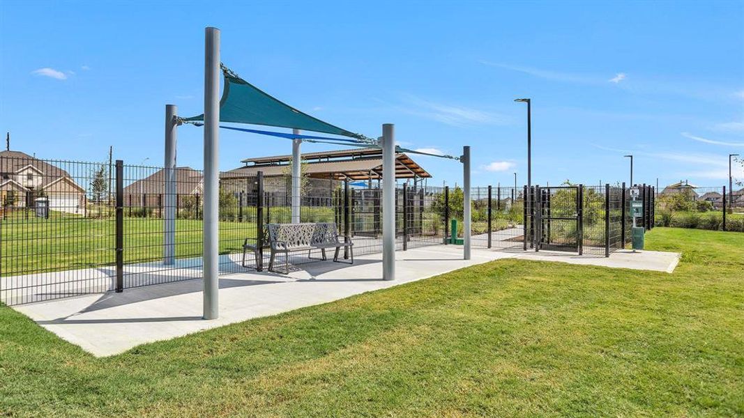 The dog park features spacious, fenced areas for both small and large dogs, as well as shaded seating for owners to relax.