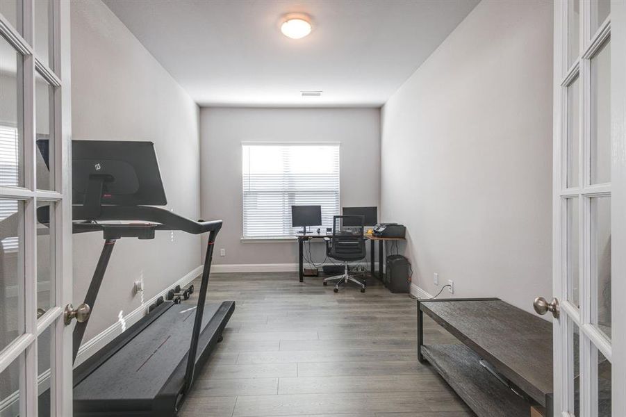 Home office featuring wood-type flooring and french doors