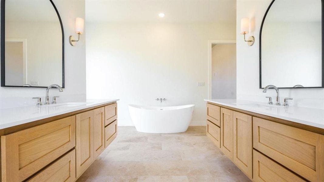 Bathroom with vanity and a bathing tub