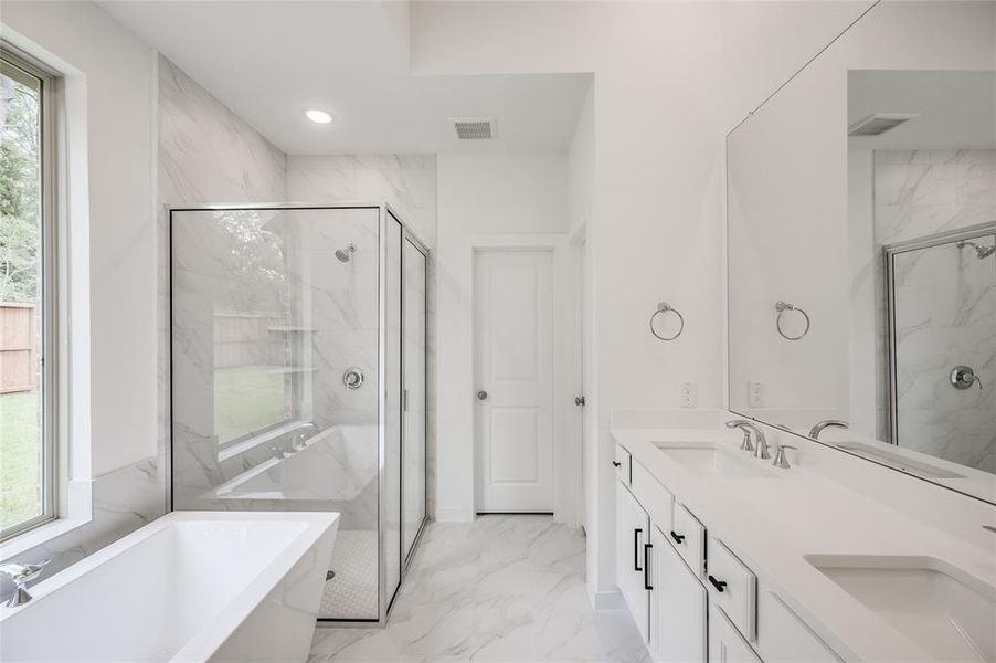 En-suite bath with soaker tub.