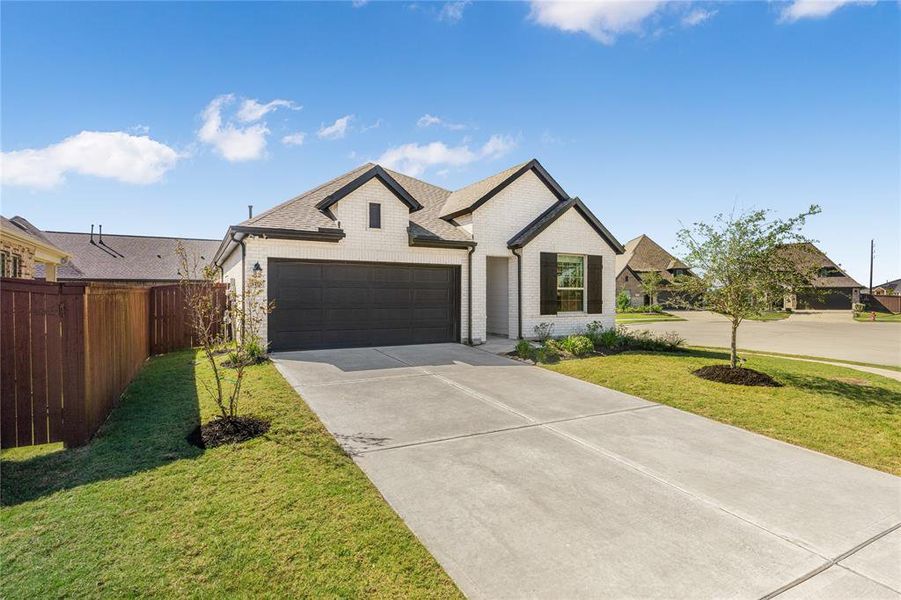 Spacious driveway leading to a two-car garage.