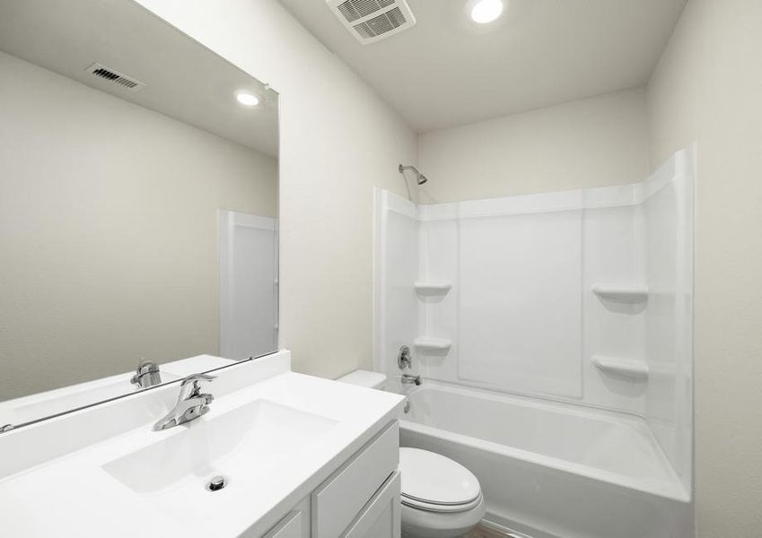 The bathroom has a tub/shower combo.