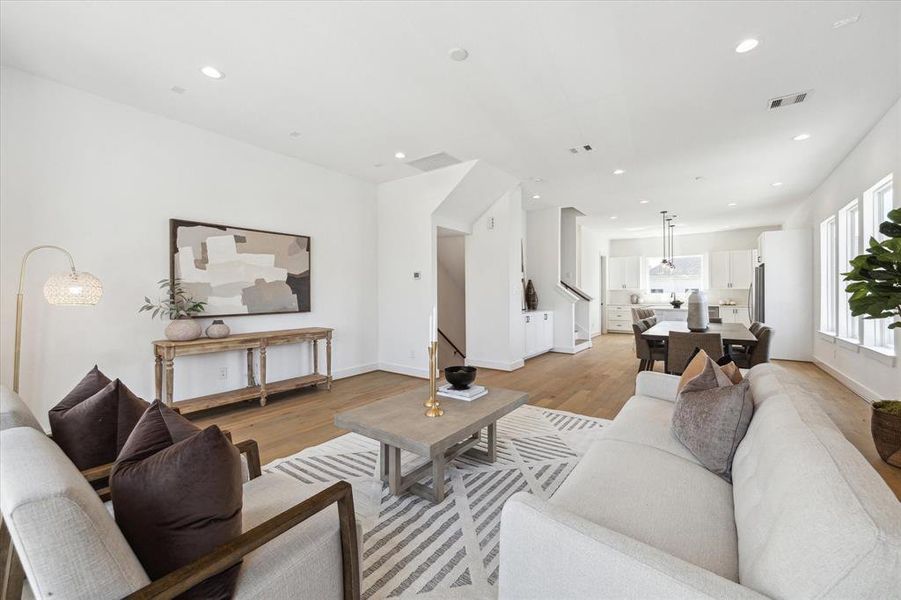 Windows carry light throughout this bright and inviting open living room.