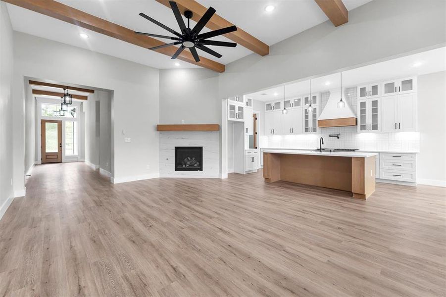 The open living area features 12 ft ceilings, energy efficient ceiling fan and gas log fireplace