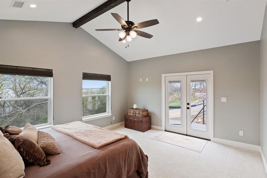 The Primary Bedroom with Vaulted Ceiling, French Doors to the Deck and Expansive Views of the Lake