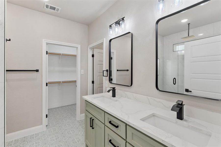 Bathroom featuring dual vanity and tile flooring