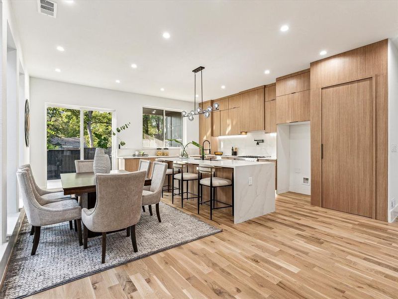 Dining space with light hardwood / wood-style floors and sink