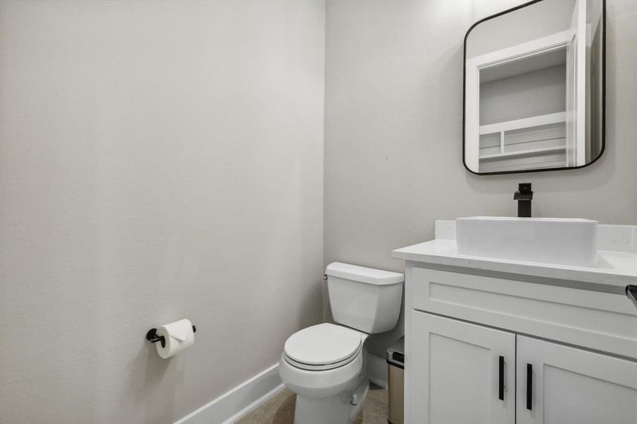 Bathroom featuring vanity and toilet