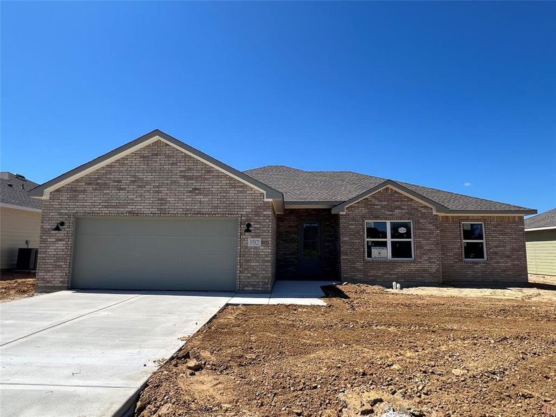 Single story home featuring central AC unit and a garage