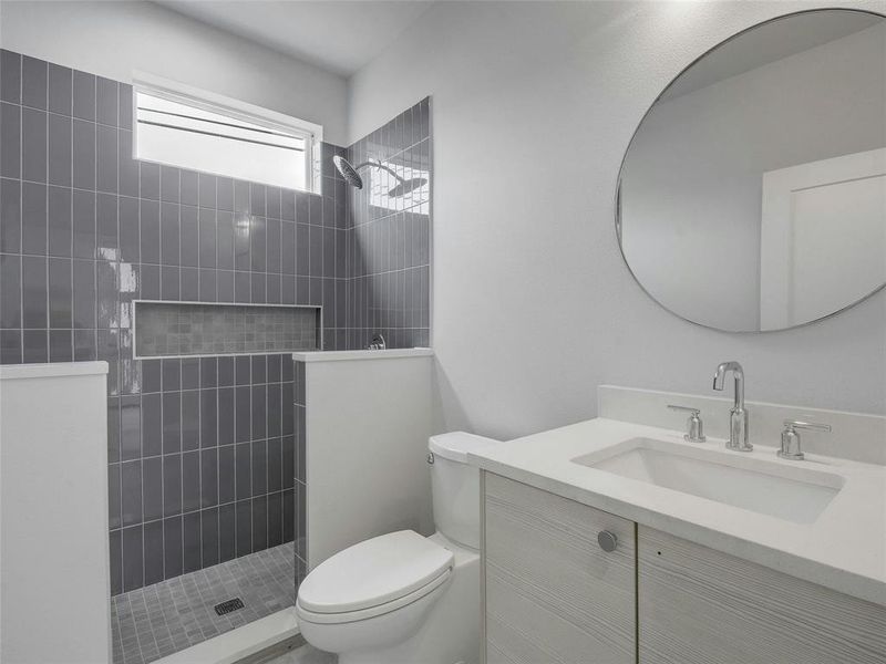 Welcome guests to a stylish sanctuary in the guest bathroom, where modern fixtures and tasteful finishes combine to create a welcoming space.