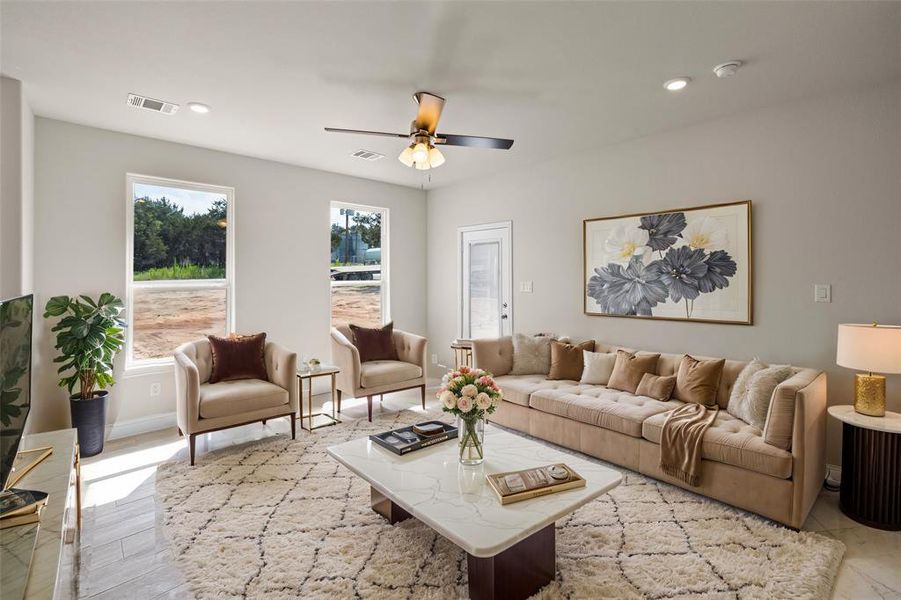 Living room with ceiling fan and plenty of natural light