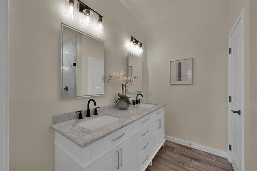 The primary bath has double sinks and LED lighted mirrors with a touch sensor for color preference.