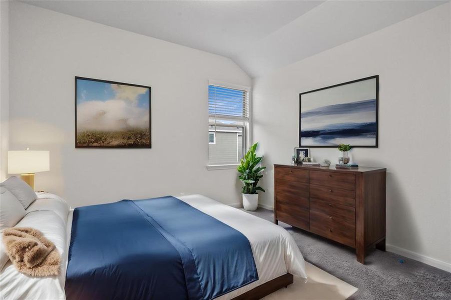 This beautifully staged bedroom exudes comfort and tranquility, with a spacious layout that allows for relaxation and rest. The large window invites natural light, enhancing the room’s peaceful ambiance, while carefully selected furnishings showcase its full potential. **This image is from another Saratoga Home with similar floor plan and finishes, not the Brayden floorplan.**