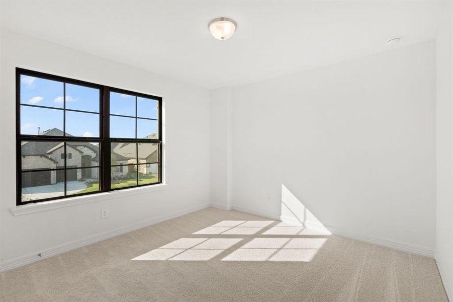 Your secondary bedroom features plush carpet, fresh paint, closet, and a large window that lets in plenty of natural lighting.