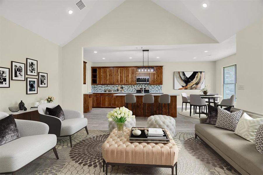 Living room featuring high vaulted ceiling and Tile Plank flooring