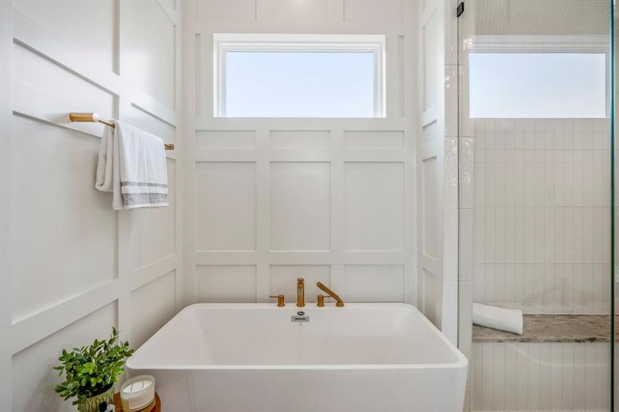 Separate stand-up shower and soaking tub, where you will exhale those long days away. Notice luxurious custom wood panelling around this tub.