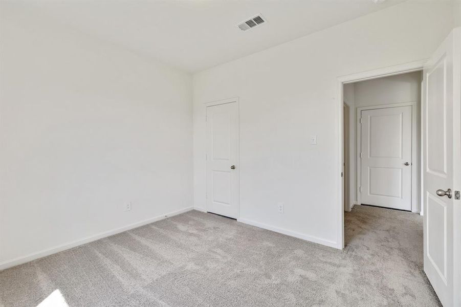 Unfurnished bedroom featuring light carpet