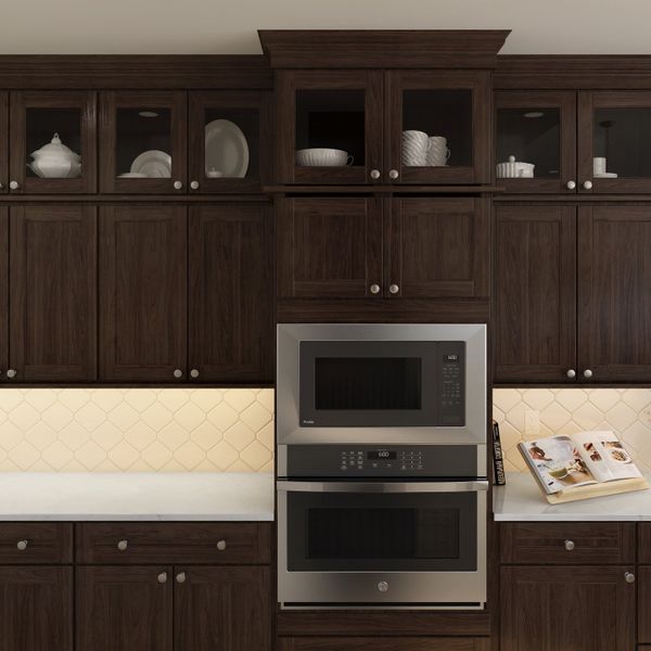 Kitchen with glass upper cabinets and hexagonal backsplash