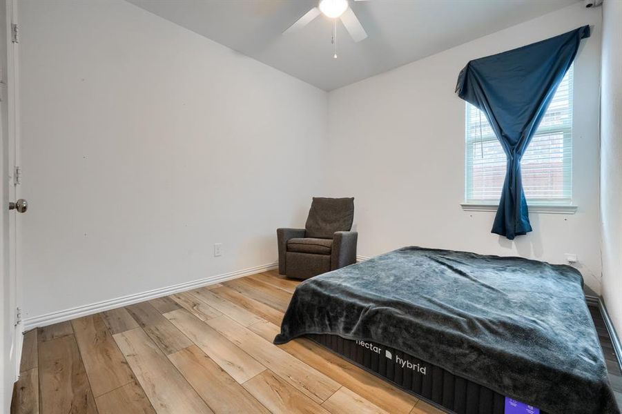 Bedroom with hardwood / wood-style flooring and ceiling fan