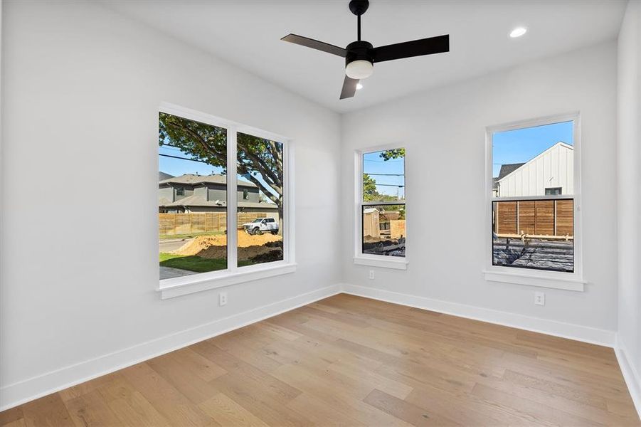 Empty room featuring ceiling fan and light wood-type flooring