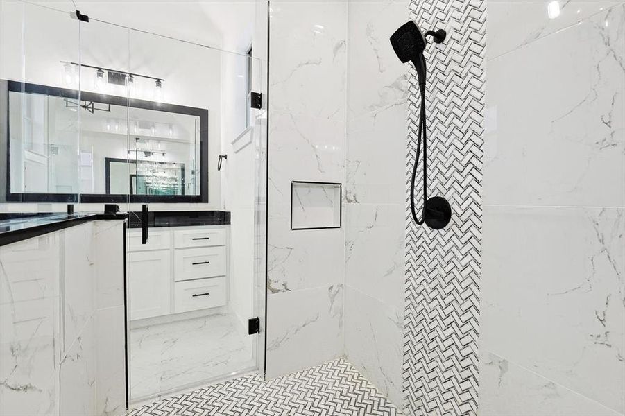 Bathroom with vanity and tiled shower