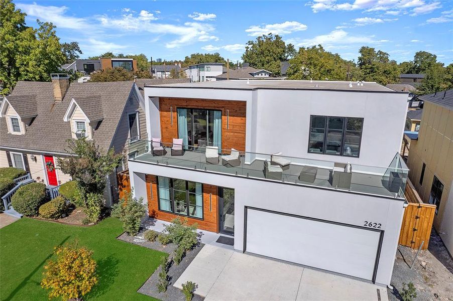 View of front of house featuring a front yard and a garage