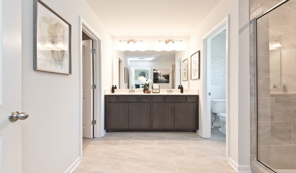 Ensuite primary bathroom features a spacious walk-in closet.