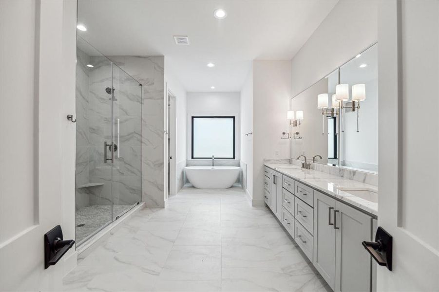 Primary bath with double sink vanity, large shower and soaking tub.